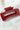 Side view of the Harper Hair Clip in Cranberry, which is a dark red rectangular plastic clip with claw teeth.