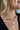 Close up view of model wearing the Take A Walk Necklace in Silver which features silver double chain layer with a rectangle design medallion.