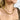 Close up view of model wearing the All That Glitters Necklace which features gold glitter and a thick chain link. 