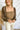 Front view of model wearing the Whirlwind Romance Top that has olive ribbed fabric, a corset style bodice with a square neckline, a cropped waist, and long sheer balloon sleeves with elastic wrists.