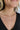 Close up view of model wearing the I Need Your Love Necklace which features double layer gold chain with a pearl rectangle stone.