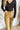 Close up front view of model wearing the Real Talk Corduroy Pants that have tan corduroy fabric, two front pockets, two back pockets, front zipper with a tortoise button closure, belt loops on waist, and wide legs