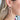 Side view of model wearing the Good Enough Earrings which features taupe beaded double circle earrings.
