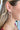 Side view of model wearing the Good Enough Earrings which features taupe beaded double circle earrings.
