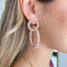 Side view of model wearing the Good Enough Earrings which features taupe beaded double circle earrings.