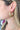 Side view of model wearing the Double The Fun Earrings which features brushed gold colors with dimensional shape.