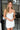 Front view of model wearing the Ice Queen Dress that has white fabric with a metallic silver floral pattern, a strapless neckline with pleated ruffle detailing, a lining, and a back zipper closure