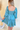 Back view of model wearing the Downtown Plans Dress which features light teal, sheen, satin fabric; square neckline, smocked back details and 3/4 sleeves with elastic and ruffle wrists.