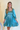 Front view of model wearing the Downtown Plans Dress which features light teal, sheen, satin fabric; square neckline, smocked back details and 3/4 sleeves with elastic and ruffle wrists.
