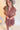 Close front view of model wearing the Look At You Satin Dress that has terracotta satin fabric, two front chest pockets, v-neckline and cuffed short sleeves