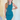 Front view view of model wearing the Over The Pines Dress which features dark green ribbed fabric, slit on the left side hem, round neckline and sleeveless.