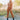 Front view of model wearing the Live Fast Pants, which have a brown faux-leather material, a high-rise fit, a front button and zipper closure, and a straight leg fit. Worn with matching top.