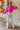Front view of model wearing The Magenta Haze Sweater features a magenta pink colored knit material, an oversized collar, a V neckline, long cuffed sleeves, and a thick bottom hem.