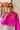 Front view of model wearing The Magenta Haze Sweater features a magenta pink colored knit material, an oversized collar, a V neckline, long cuffed sleeves, and a thick bottom hem.