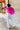 Back view of model wearing The Magenta Haze Sweater features a magenta pink colored knit material, an oversized collar, a V neckline, long cuffed sleeves, and a thick bottom hem.
