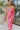 Frontal view of the Pink Dreams Dress that features a monochromatic pink houndstooth pattern, a cowl neckline, a sleeveless design with thin adjustable straps, and a side slit.