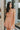 Frontal view of the Something Like That Dress that features a salmon satin material, a cowl neckline with cups at the bust, a sleeveless design with thin adjustable straps, a waist cut-out, an elastic waistline, and a criss-cross strap back.