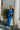 Full body view of model wearing the Be You Pants which features royal blue pleated fabric, elastic waistband and flare pant with lettuce detail on the hem.