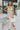 Frontal view of the Chasing The Disco Dress that features a multi-colored swirl print, a cowl neckline, a sleeveless design with thin straps, an open back, and a midi length.