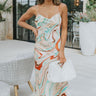 Frontal view of the Chasing The Disco Dress that features a multi-colored swirl print, a cowl neckline, a sleeveless design with thin straps, an open back, and a midi length.