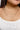 Close up view of model wearing the On The Lookout Necklace which features two gold layers, one layer with gold flat design and the other layer is a gold roping design.