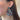 Close up view of model wearing the Put A Ring On It Earrings which features multi color stones embellished ring shaped.