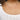 Close up view of model wearing the All The Layers Necklace in Grey which features three-layered gold chain links with grey, taupe, cream and clear stones.