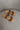Front lay view of the Beach by Matisse Amalia Flat Sandal in Tan which features light brown braided upper, two straps, slide-on style and flat sole. 