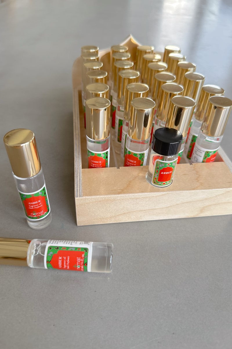 Image of display of mutiple Nemat Amber Fragrance Oil - 10 mL Roll Ons.