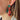 Side view of model wearing the O Christmas Tree Earrings which features an embellished red truck with a tree. 