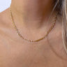 Front view of model wearing the Fairytale Ending Necklace which features single-layered gold chain link with clear beads.