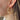Side view of model wearing the Full of Jazz Earrings which features topaz large jewels on gold hoops. 