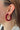 Side view of model wearing the Scarlet Velvet Hoops which features suede burgundy open hoops.