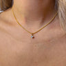 Front view of model wearing the Let It Shine Necklace which features double-layered with gold chain link and gold flat layer with a clear rhinestone attachment.