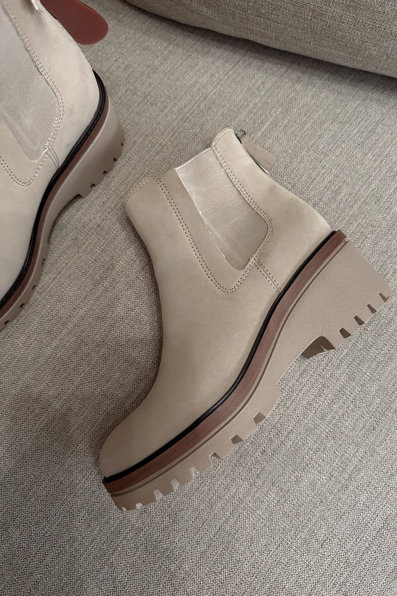 Close up view of the Sefi Boot in Sand which features beige suede upper fabric, side elastic paneling, contoured footbed, rubber outsole and rounded toe.