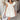 Front view of model wearing the Sweet Life Bubble Dress that features ivory satin fabric, mini length, a bubble hem, a round neckline, ruffle straps and a monochromatic back zipper with a hook closure.