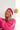 Front view of model wearing the Stay Cozy Beanie in Beige, that features beige sherpa fabric, pink cable knit trim, and a yellow pom pom.