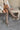 Front view of model wearing the Risky Boot in Dark Taupe which features dark taupe suede fabric, chunky lug platform sole, back pull tab, round toe and inside side monochrome zipper.