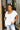 Frontal view of the Got Your Back Top that features a white gauze material, straight neckline, a short ruffle sleeve, frayed stitching details through out, and a flowy fit.