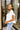 Side view of the Got Your Back Top that features a white gauze material, straight neckline, a short ruffle sleeve, frayed stitching details through out, and a flowy fit.